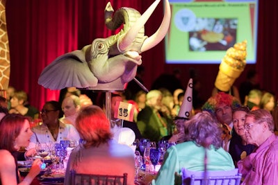 Oversized circus-themed centerpieces of lions, horses, and ice cream treats hovered over each table.