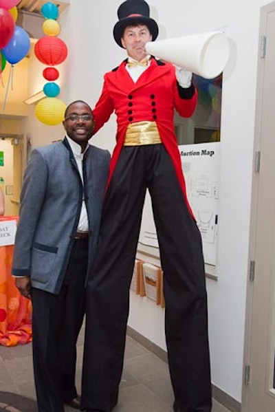 Event producer Andre Wells posed with a stilt walking performer.