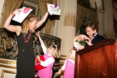 A.C.S. Mother of the Year Muffie Potter Aston was presented with flowers by her husband, Dr. Sherrell Aston, and handmade trophy drawings by her twins, Bracie and Ashleigh.