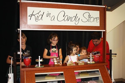 The 'Kid in a Candy Store' activity let young guests strap on aprons and pose in a model shop. Parents used the activity as a photo opportunity.