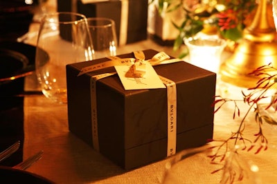 A custom jewelry box with a Mon Jasmin Noir charm inside marked each place setting at the dinner table.