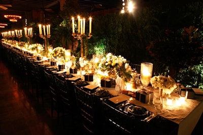 Designed to look like a private, overgrown garden in the Mediterranean, the dinner area was enclosed by tall hedge walls and filled with plenty of plenty of green flora. The 80 guests sat at one long black croc table.