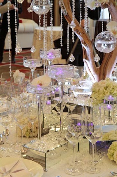 Naakiti Floral Design's table, known as 'Winter Wedding in Kyoto' took a Zen approach to the design, using simple, inexpensive materials. Mirrors and crystals made the tablescape sparkle. Upside-down containers created a snowflake effect�'a new use for a standard product.