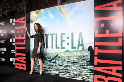 Celebrities and guests posed in front of the step-and-repeat wall before the screening at the Village Theatre on Broxton.