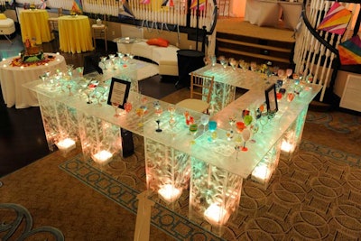 IM Events created LED-illuminated plexiglass tables to display the wine and martini glasses painted by the children.