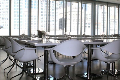 Floor-to-ceiling windows overlook the city skyline.