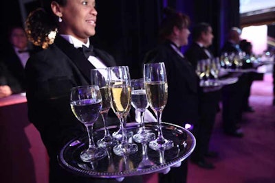 Waiters with trays of champagne and wine stood at the ready at the entrance.