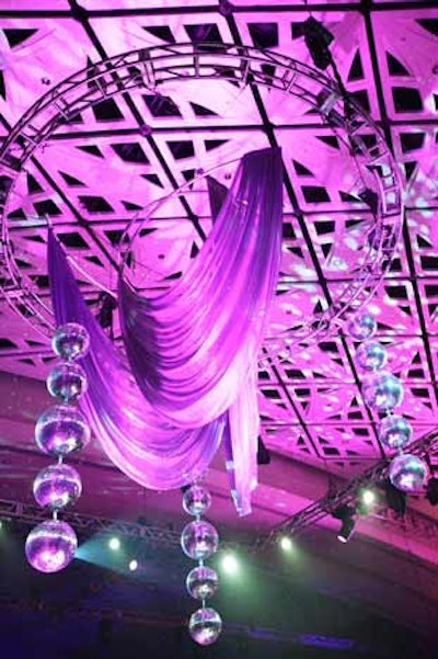 Hargrove suspended fuchsia drape and disco balls above the small stage in the center of the dinner tables.
