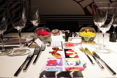The creative crew left the tabletops spare, save for glasses filled with brightly colored gerbera daisies and menus bedecked in images from the Pop artists.