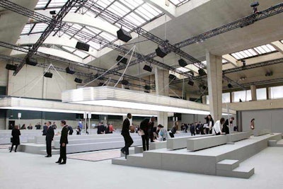 Held for the second season at the Tennis Club de Paris, designer Phoebe Philo's show for Céline on March 6 turned the cavernous concrete venue into a modern studio with low bench seating and bright overhead lighting. As an interesting architectural touch, the parquet runway was inlaid with one diamond-shaped slab of pink marble.