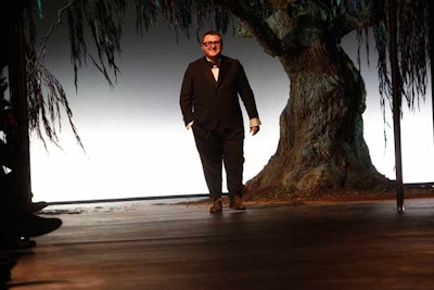 A giant rectangle was cut into Lanvin's show set to reveal a massive tree, the imposing branches of which formed a dramatic arch that models emerged through. Held on March 4 at the Espace Ephémère Tuileries, the outing for Alber Elbaz was built around the weeping willow and featured a full-moon backdrop to symbolize the designer's concept of traditional roots.