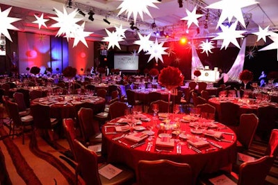 Hanging white stars and all-red tables set the mood inside the Ritz-Carlton Toronto for the Canadian Stage Theatre Ball.
