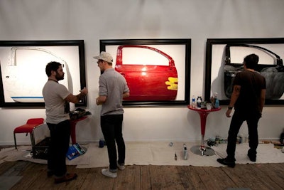 In the receiving area, the former home of the Levi's Store, artists leave their mark on framed Fiat doors.