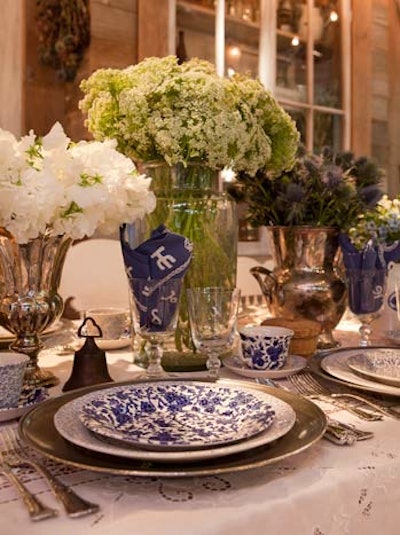 Ralph Lauren Home went with a rustic, country porch feel complete with bandannas as napkins, mix-and-match blue and white plates, and single-bloom arrangements in large vintage-looking vessels such as glass jars and silver vases.