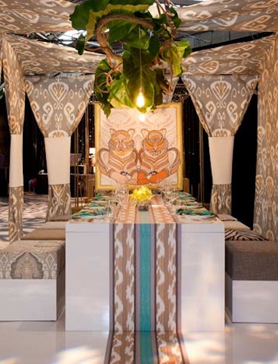 Echodesign's space had a resort feel, with airy printed fabrics, oversize greenery, tropical artwork, and chartreuse orchids. One unusual detail was the table's patterned runner, which extended all the way down to the floor.