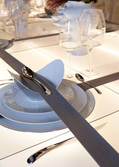MMPI's table by D'Apostrophe Design had place settings held in place by long bands of latex.