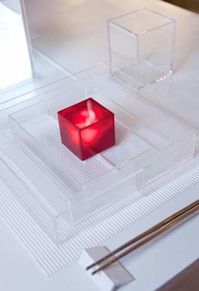 At the New York School of Interior Design's setting, overseen by Philip Gorrivan, Lucite boxes served as place settings. Each one contained a glowing red light and silver chopsticks.