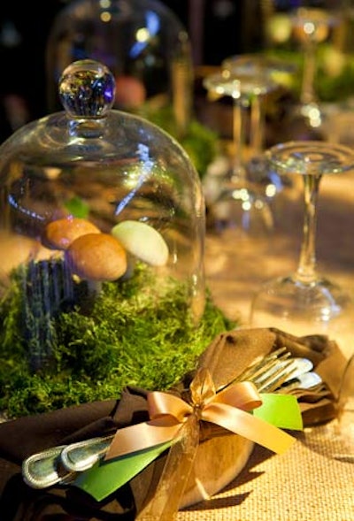 Fashion Institute of Technology students worked with design mentor Preston Bailey to create a forest setting, complete with wood chargers and terrarium plate toppers. For an extra touch, the flatware and napkins were gathered together with a ribbon.