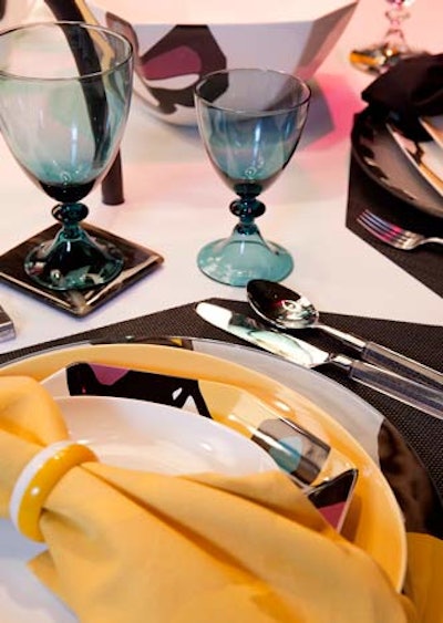 Diane von Furstenberg's table featured her new line of dishes, which come in an array of patterns and angular shapes. Lucite cutlery and blue glassware added to the modern, colorful look.