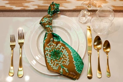 Echodesign used silky patterned napkins tied in knots and matte gold flatware.