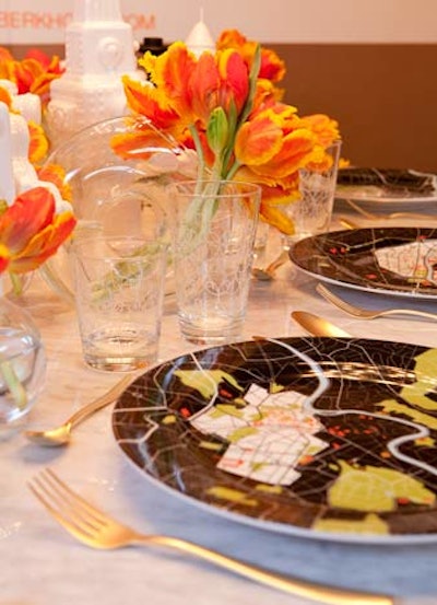 Bobby Berk Home and Marc Wilson Design's playful place settings had plates with maps, gold flatware, and clear tumblers with swirly patterns.