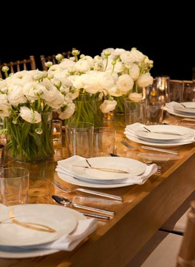 At Eric Warner's golden-hued table for Aesthete Ltd., each plate had the image of a gold ribbon. Small LED votives immersed in gold glitter added to the sparkly effect.