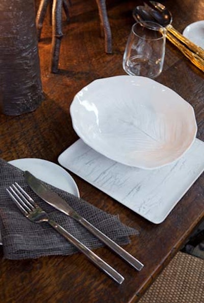 Mary Davis Interiors had a striking minimalist array of dishware, both round and square, plus mesh napkins.