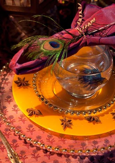 At Tessa Morehouse's exotic setting for Velvet Antler, each guest got a small fishbowl that contained a beta fish. Each plate was trimmed with a handful of star anise and topped with a napkin adorned with a peacock feather.
