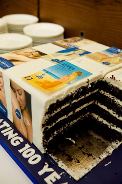 A two-tier cake was decorated with both vintage and modern Nivea advertisements.