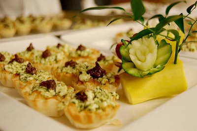 The venue's catering department served five passed hors d'oeuvres during the cocktail hour, including mini phyllo tartlets with pesto-infused mozzarella and olive caponata.