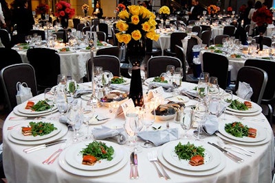 The venue provided white and silver linens and chairs to match the event logo designed by Kamali.