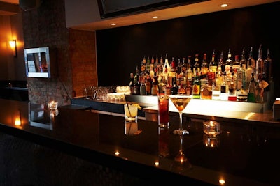 The bar is backed by a long glass mirror.