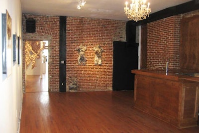 Gallery B's exposed brick walls and wooden bar add an industrial element to the predominately white gallery's ambience.