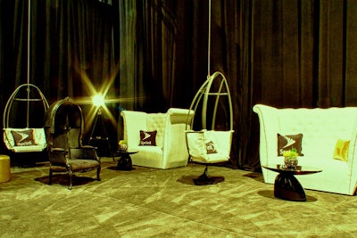 At the back of the room, designers created a seating area with swing chairs, high-back chairs, and tufted love seats, all topped with branded pillows.