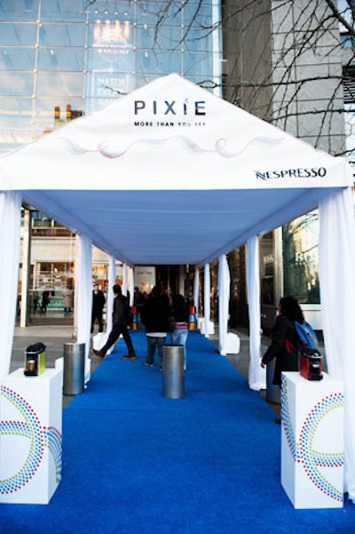 A bright blue carpet led guests from the street into the store inside the mall. MAS Event & Design used this section for branding, decorating it with the new machine from Nespresso and staffing it with girls in key brand colors.