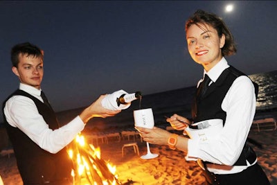 Waiters welcomed guests to the beach bonfire with white goblets of Moët Ice Imperial. 'We wanted to ensure the celebration ended on a high note,' Jacobson said.
