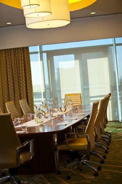 The executive board room can comfortably seat 12 and has floor-to-ceiling windows along the perimeter wall with views of Arlington and Washington.