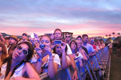 Fans packed into the festival grounds during a colorful Sunday sunset.