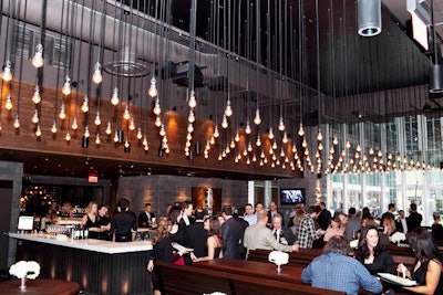 Single-bulb light fixtures hang from the ceiling in the lounge area.