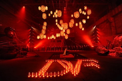 With lasers in hand, 100 masked Chinese men animated the hazy space, choreographed to shine the red beams to music played live by a harpist. A giant installation of lanterns formed the fashion house's 'DVF' logo overhead, while red votives composed the same shape on the floor of the space.