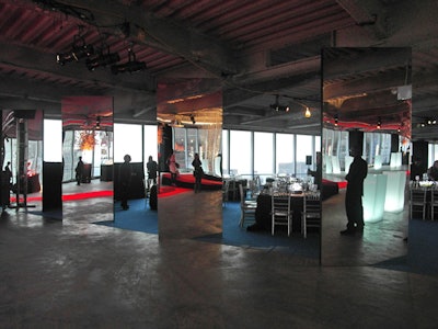 To divide the cocktail space from the dinner area, Baura New York used four freestanding mirror panels. Standing at an angle, this informal gateway also served to reflect the chandeliers and the city lights seen out the windows.