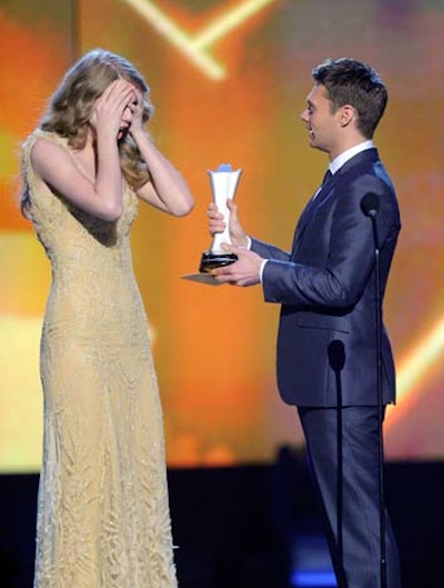 Taylor Swift accepted the award for Entertainer of the Year from Ryan Seacrest.
