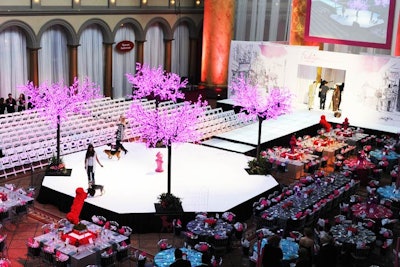 Syzygy arranged the central event space with dinner tables on one side of the runway and V.I.P. seating on the other.