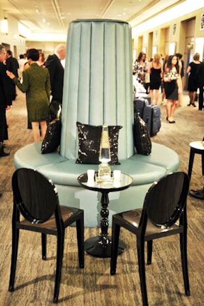 Black Ghost chairs surrounded mirrored drink tables in the lobby.