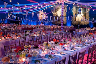 Draped in midnight blue fabric, the tent for the post-show dinner was designed to mix whimsical British imagery with the ideas from War Horse's World War I setting. This included miniature British and American flags, which doubled as paddles during the evening's auction.
