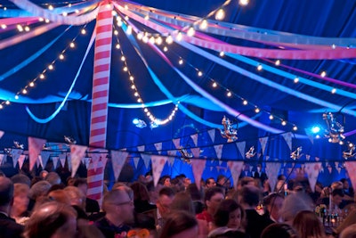 To give the 600-seat dinner space a more intimate feel, David Stark and his team threaded string bulbs and pink ribbons overhead. A maypole stood in the center of the tent.