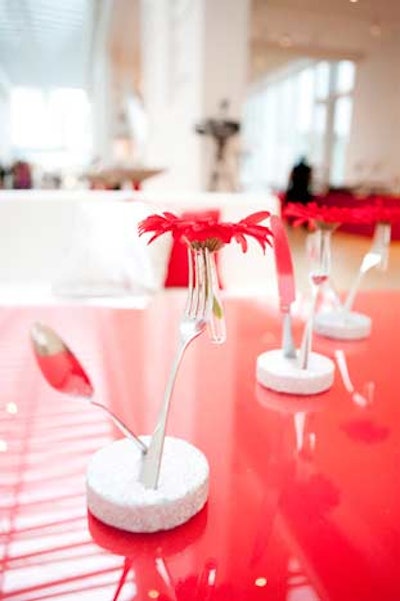 Modern flower arrangements incorporated utensils to underscore the restaurant-centric theme.