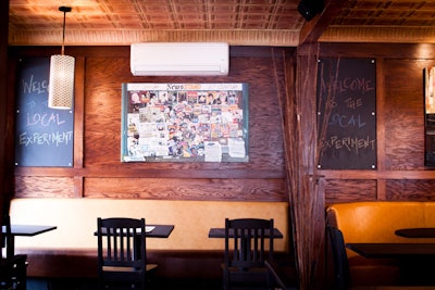 The look mixes rustic wood with bold, yellow leather seating.