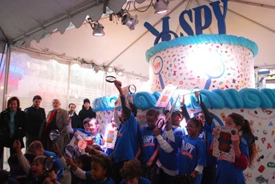 For the event, Scholastic created a 12-foot-tall cake-shaped structure and invited 20 second graders from Manhattan Country School to participate in a picture-riddle-based contest.