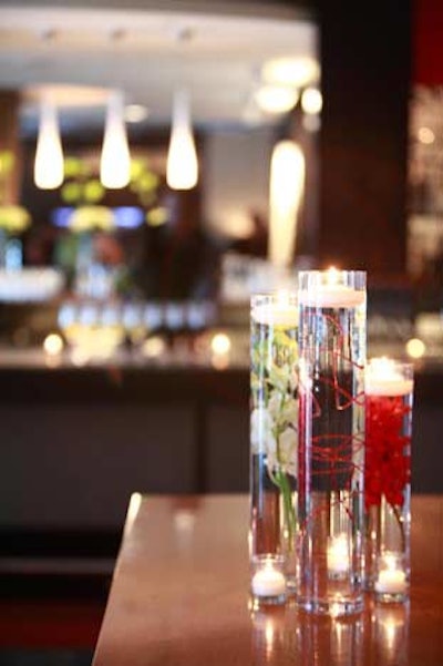 Tall floral arrangements of floating flowers and candles adorned the tables and bars in Art and Soul during the cocktail reception.